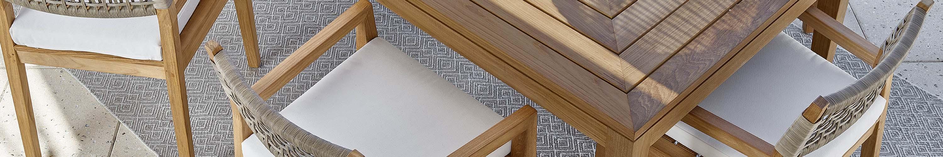 Wood and cloth chairs on an outdoor rug